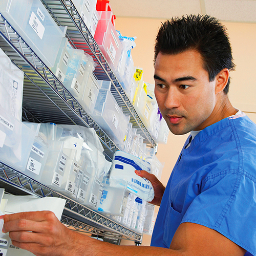 Pharmacy Technician helping prepare and give out prescription medication.