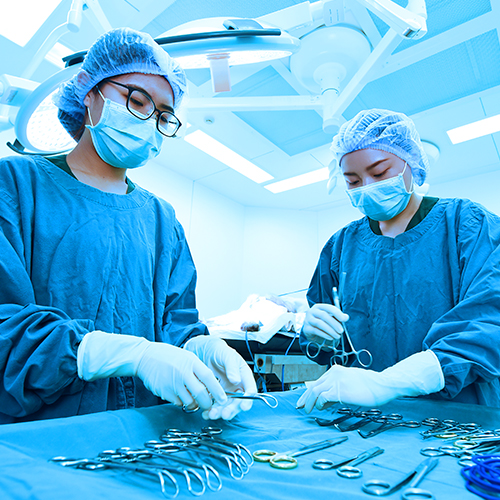 Surgical technicians ensuring that all of the equipment needed for the procedure is properly disinfected and assembled.